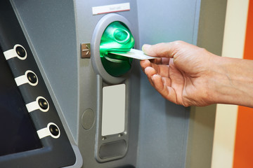 Inserting plastic card into ATM
