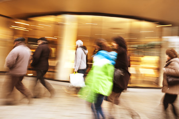 A shopper walking in front of shop window