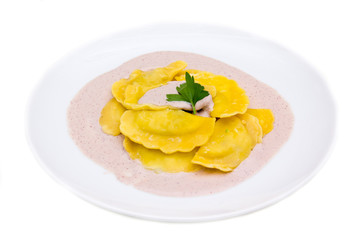 Ravioli with radicchio sauce on white background