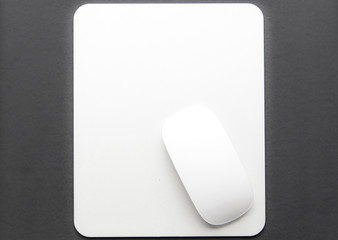 White mouse pad on a black background. Device, workplace, no people, technology, computer, work, pc, office, laptop, business, design, digital, desk, modern, desktop, equipment, media