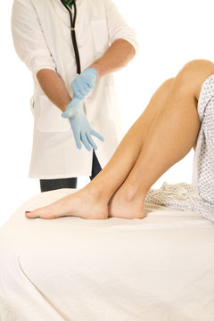 Woman patient legs doctor put on glove