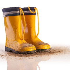 Yellow rubber boots for kids on white background