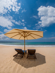 sunbeds with umbrellas on a beautiful sandy beach