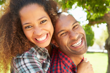 Head And Shoulders Portrait Of Loving Couple Outdoors