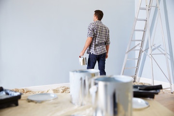 Fototapeta premium Man Decorating Nursery For New Baby