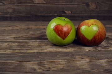Heart shaped apples on wooden planks