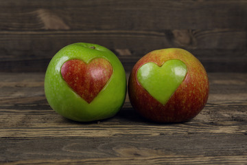 Heart shaped apples on wooden planks