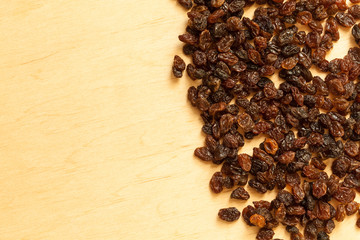 Border frame of raisin on wooden table background