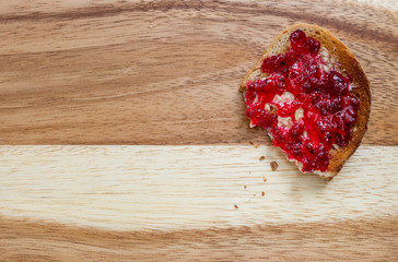 Toasted bread with butter and redcurrant jam. Copy space on left