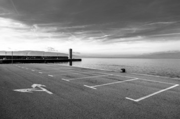 Empty parking area with sea