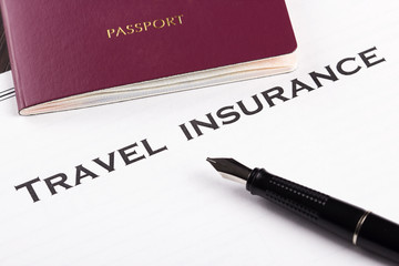Travel insurance form with pen and passport
