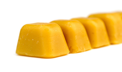 Blocks of natural Australian beeswax isolated on white