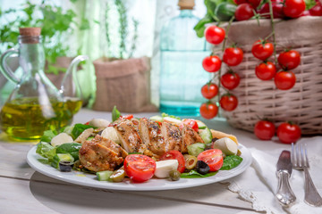 Salad with chicken cooked in a sunny kitchen