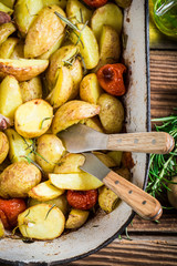 Roasted potatoes with herbs and tomatoes