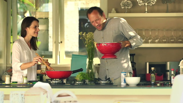 Boyfriend burning himself during cooking  with girlfriend