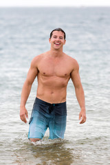 young man walking in ocean water