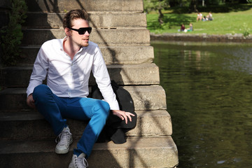 Man in his 20s looking on the river