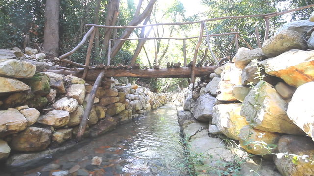 city ruins Olimpos bridge through a stream