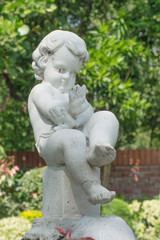 Fototapeta na wymiar Stone statue of a child