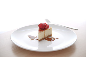 Small slice of cheesecake on a big plate