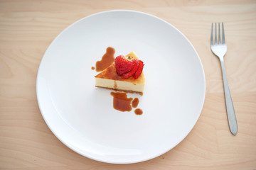 Small slice of cheesecake on a big plate