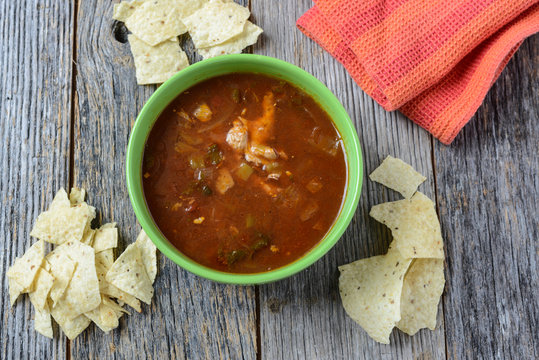 Tortilla Soup with Chips on Rustic Wood Background