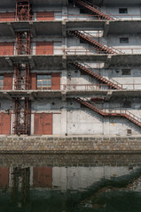 An old factory building along the canal with slight reflections.