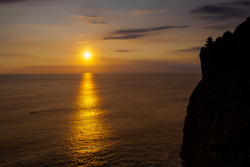 Fototapeta na wymiar Sunset at a cliff in Bali Indonesia.