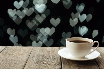 Cup of hot drink on bright background