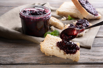 Delicious black currant jam on table close-up