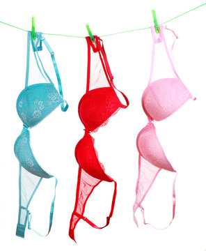 Woman bra hanging on rope isolated on white background