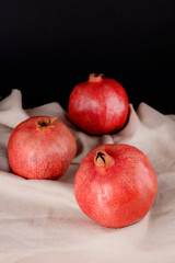 Juicy ripe pomegranates on dark background