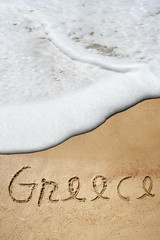 Conceptual Greece text in sand and water