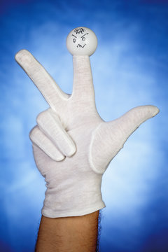 Angry finger puppet over blue background