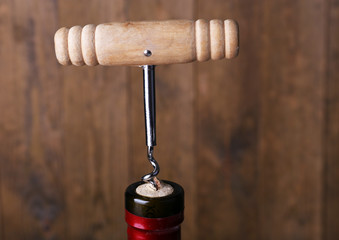 Bottle opener close-up, on wooden background