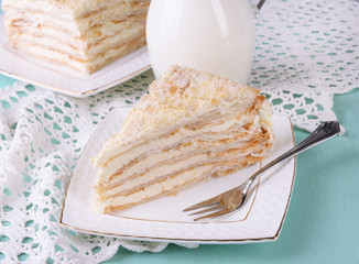 Napoleon cake on plate on table close-up