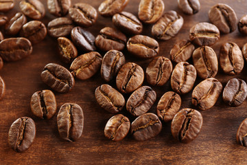 Coffee beans on wooden background, close-up