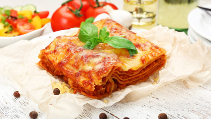 Portion of tasty lasagna on table