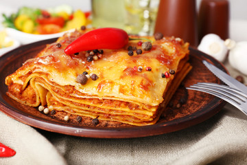 Portion of tasty lasagna on table
