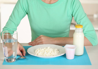 Girl and dietary food at table close-up