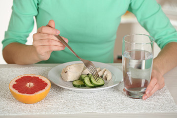 Girl and dietary food at table close-up