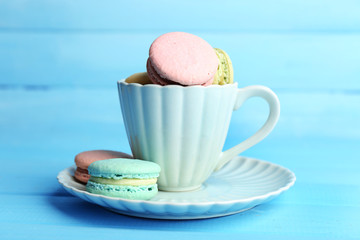 Assortment of gentle colorful macaroons in colorful mug