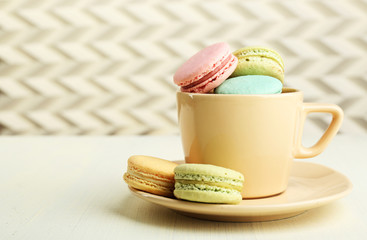 Assortment of gentle colorful macaroons in colorful mug