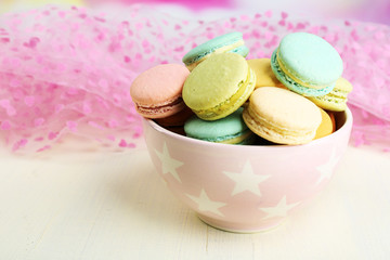 Assortment of gentle colorful macaroons in colorful bowl