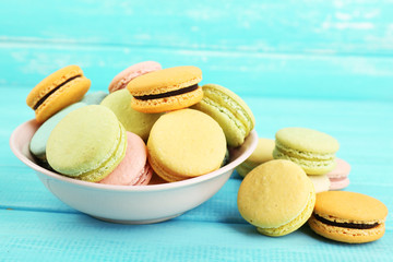 Assortment of gentle colorful macaroons in colorful bowl