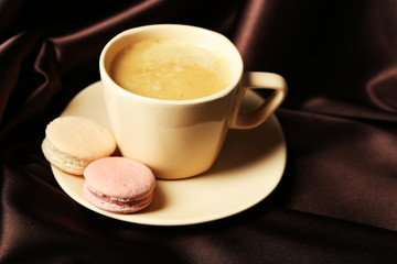 Gentle colorful macaroons and black coffee in mug