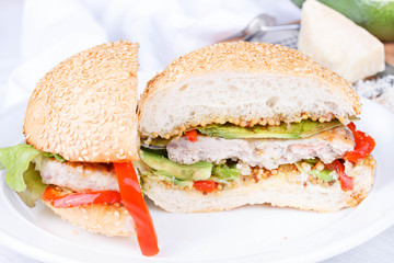 Burger with turkey and avocado on a sesame seed bun