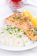 Steamed salmon with fresh herbs and lemon. Rice as a garnish