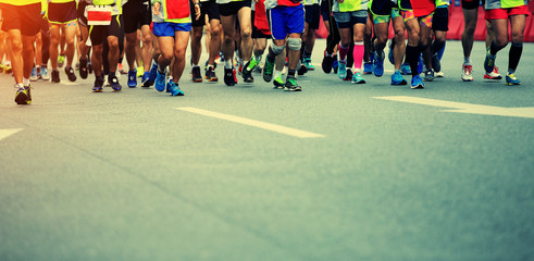 marathon runner legs running on street