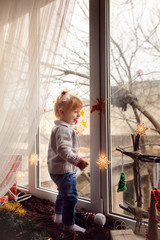 adorable baby in the room with gifts